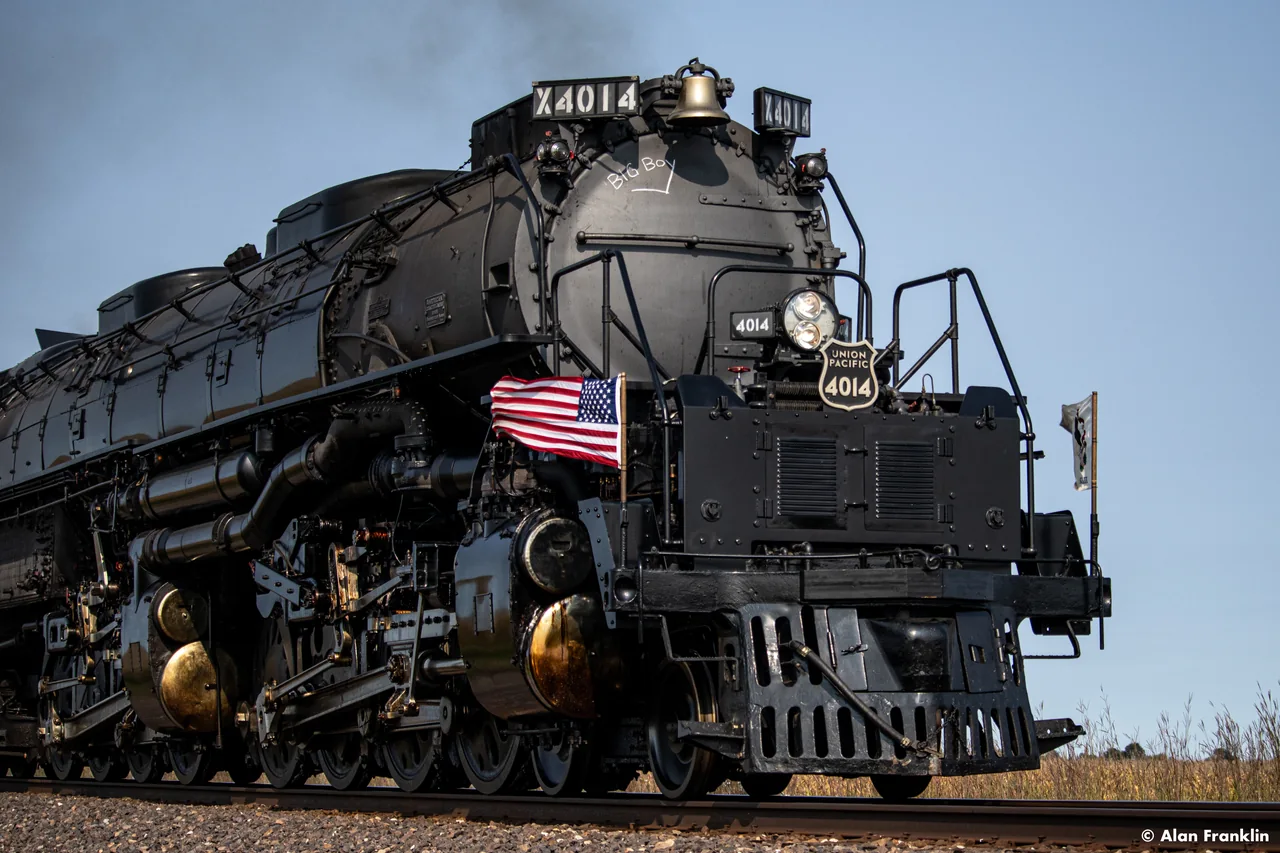 Union Pacific Big Boy 4014 seen from a low angle, with an American flag at the front.